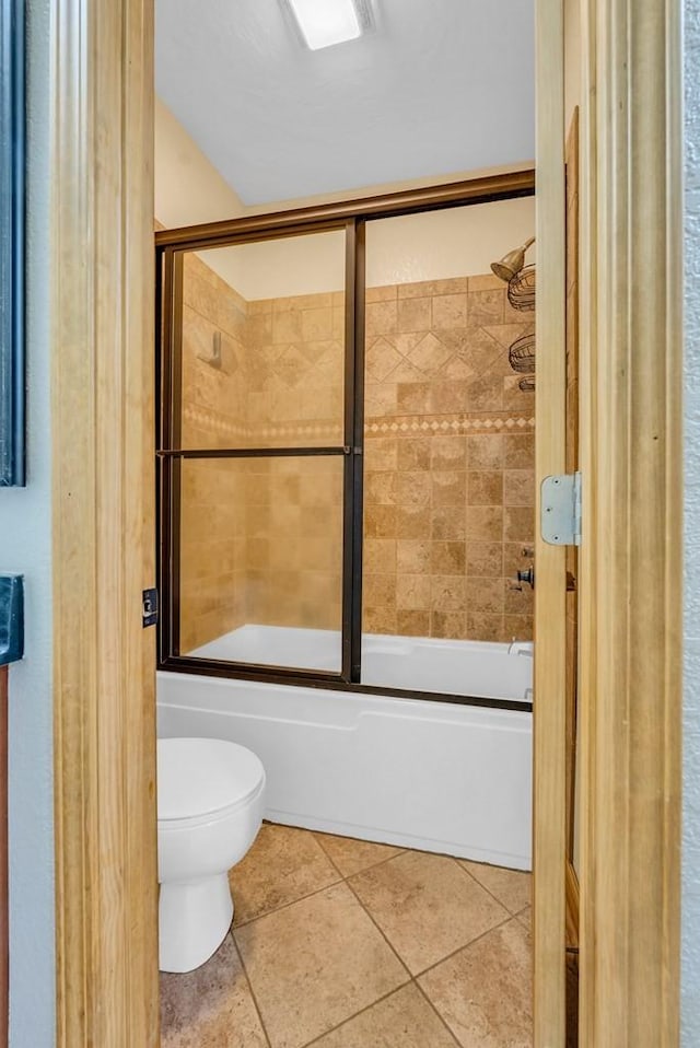 700 Falls Rd, Monterey, TN 38574 - bathroom with toilet, tile patterned flooring, and bath / shower combo with glass door