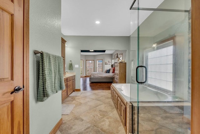 700 Falls Rd, Monterey, TN 38574 - bathroom featuring vanity, ensuite bath, plenty of natural light, and a washtub