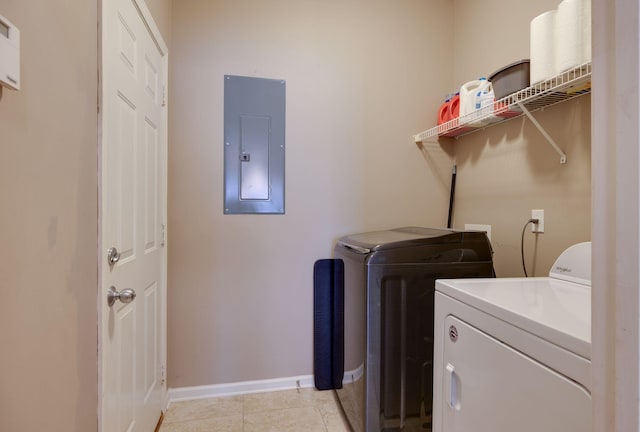 laundry area featuring light tile patterned floors, baseboards, washer and dryer, electric panel, and laundry area