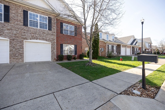 view of front of home with a front yard, an attached garage, a residential view, and driveway