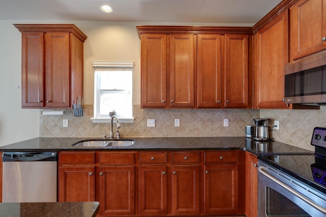 kitchen with recessed lighting, dark stone counters, decorative backsplash, stainless steel appliances, and a sink