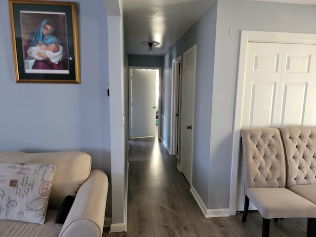 hallway with wood finished floors and baseboards