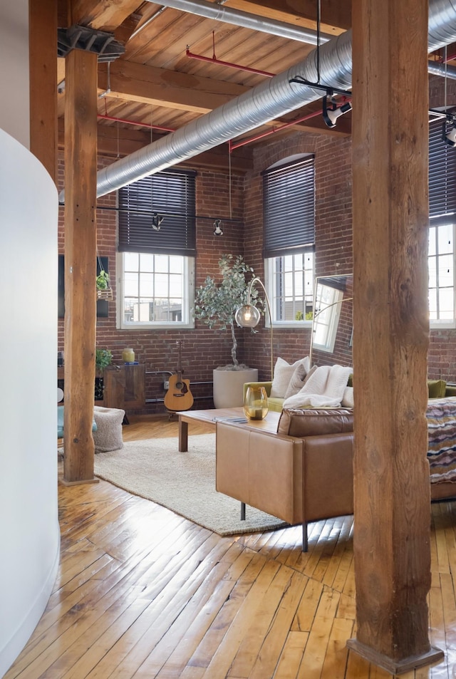 1400 Rosa L Parks Blvd Unit 318, Nashville, TN 37208 - living area with hardwood / wood-style floors, brick wall, and a healthy amount of sunlight