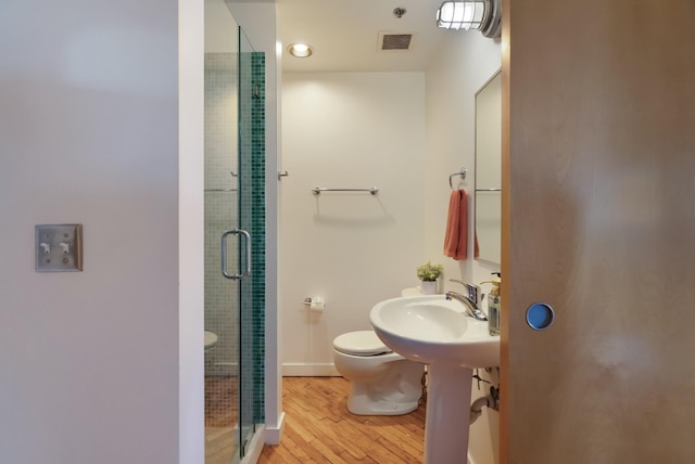 1400 Rosa L Parks Blvd Unit 318, Nashville, TN 37208 - full bathroom with a shower stall, visible vents, toilet, wood finished floors, and baseboards