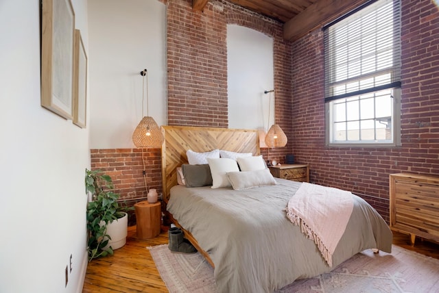 1400 Rosa L Parks Blvd Unit 318, Nashville, TN 37208 - bedroom featuring brick wall, a high ceiling, hardwood / wood-style flooring, and beamed ceiling
