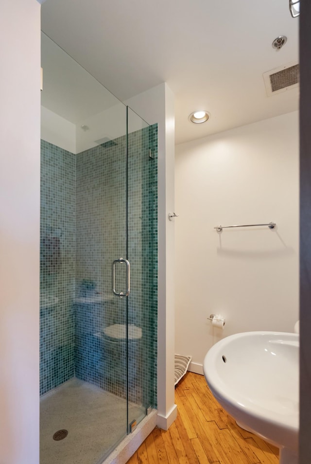 1400 Rosa L Parks Blvd Unit 318, Nashville, TN 37208 - bathroom with visible vents, baseboards, a stall shower, and wood finished floors
