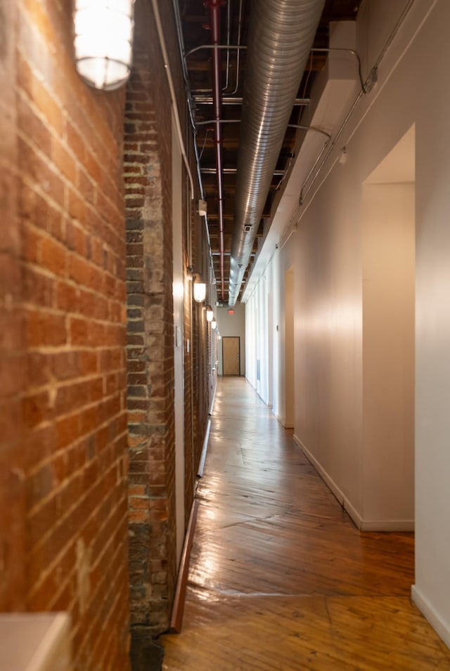 1400 Rosa L Parks Blvd Unit 318, Nashville, TN 37208 - corridor with brick wall, baseboards, and hardwood / wood-style floors