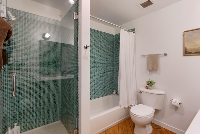 1400 Rosa L Parks Blvd Unit 318, Nashville, TN 37208 - full bath with visible vents, toilet, wood finished floors, tiled shower / bath combo, and baseboards
