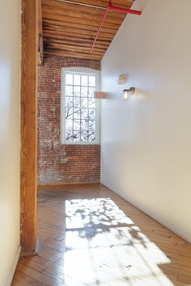 1400 Rosa L Parks Blvd Unit 318, Nashville, TN 37208 - hallway featuring wood ceiling, brick wall, and wood-type flooring