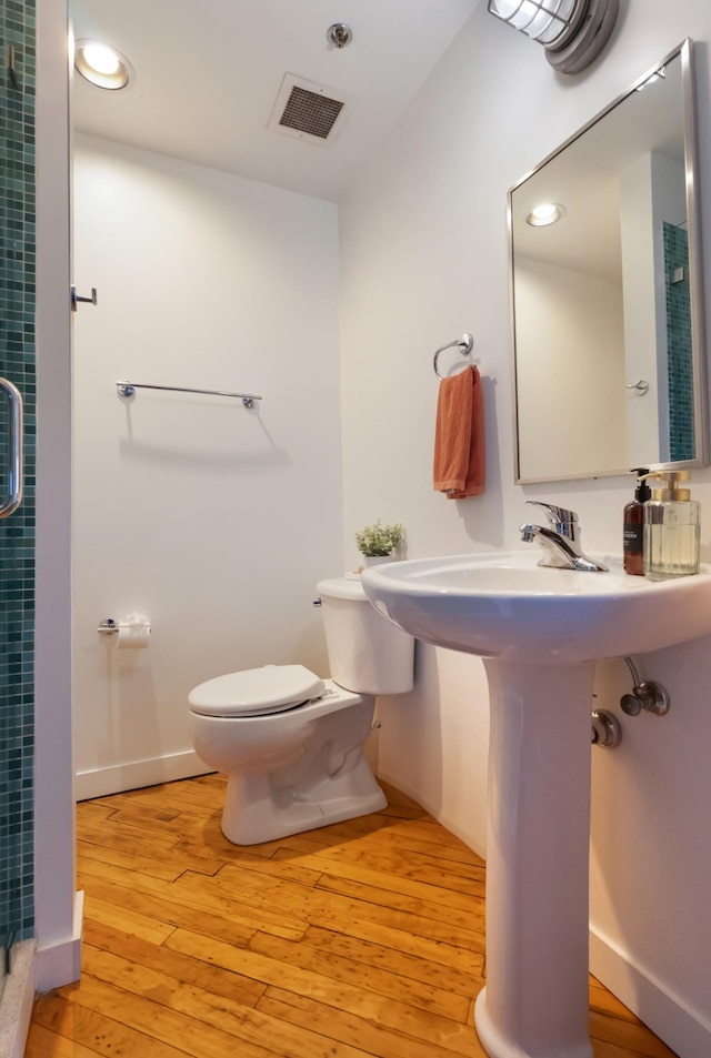 1400 Rosa L Parks Blvd Unit 318, Nashville, TN 37208 - full bath with toilet, a stall shower, visible vents, and hardwood / wood-style flooring