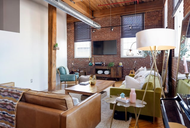 1400 Rosa L Parks Blvd Unit 318, Nashville, TN 37208 - living room with brick wall, a high ceiling, and wood finished floors