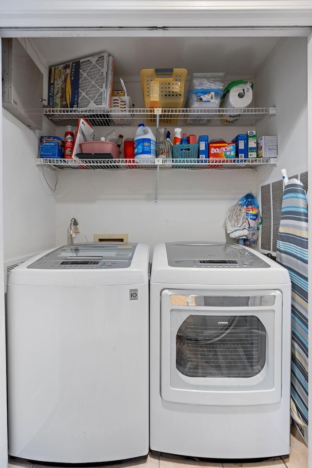 clothes washing area featuring washing machine and dryer and laundry area
