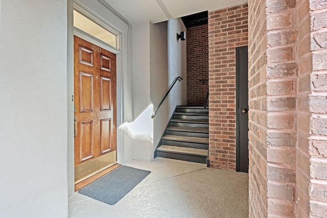 doorway to property with brick siding