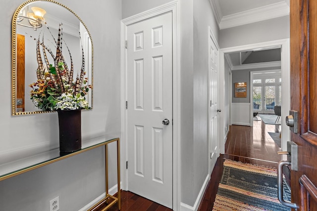 entryway featuring dark wood-type flooring and ornamental molding