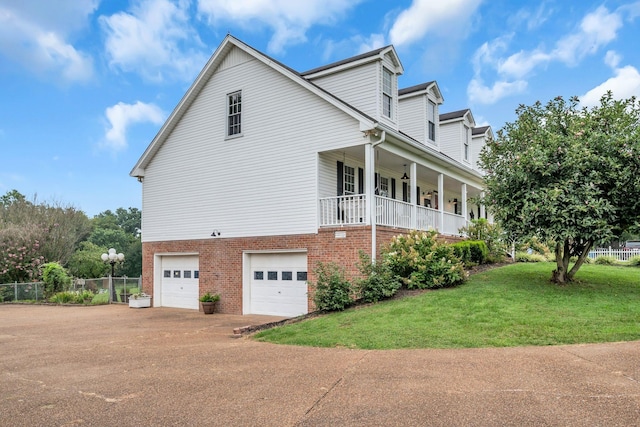 2712 Long Hollow Pike, Hendersonville, TN 37075 - view of side of home featuring a yard, covered porch, fence, brick siding, and a garage