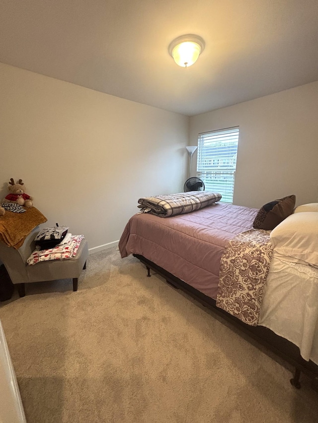 bedroom with carpet floors and baseboards