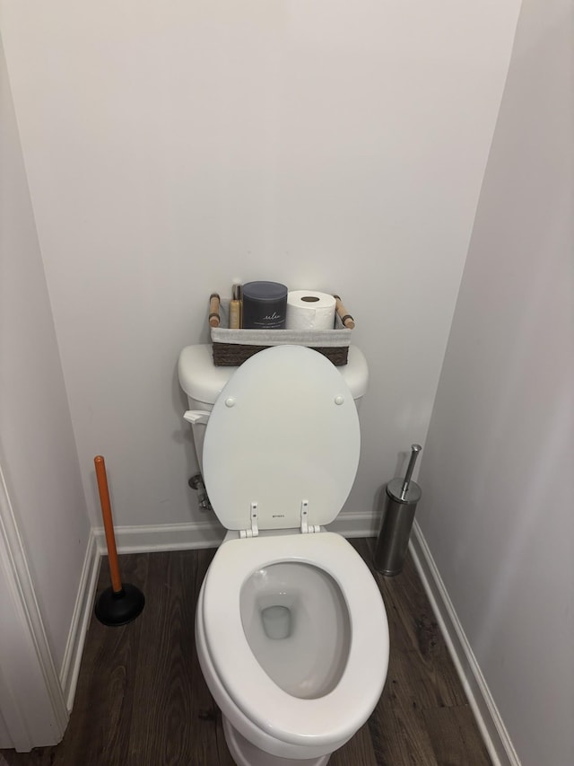 bathroom featuring baseboards, toilet, and wood finished floors