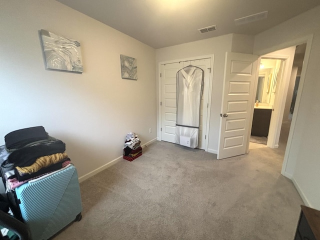 living area featuring visible vents, baseboards, and carpet floors