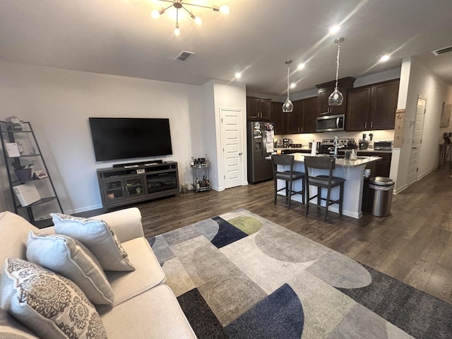 living room featuring recessed lighting, baseboards, visible vents, and dark wood-style floors