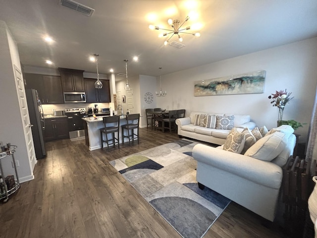 living area featuring visible vents, dark wood finished floors, baseboards, a chandelier, and recessed lighting