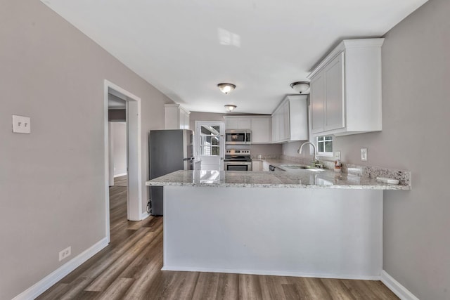 1500 Lock B Rd S, Clarksville, TN 37040 - kitchen with stainless steel appliances, light stone countertops, a peninsula, and a sink