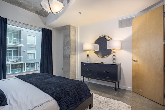 600 12th Ave S Unit 521, Nashville, TN 37203 - bedroom with concrete flooring, baseboards, and visible vents