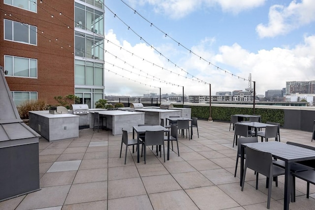 600 12th Ave S Unit 521, Nashville, TN 37203 - view of patio featuring a view of city, outdoor wet bar, grilling area, outdoor dining space, and an outdoor kitchen