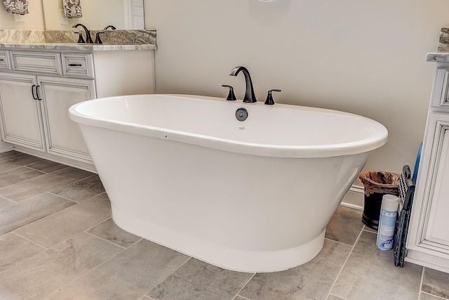 full bathroom with a soaking tub and vanity