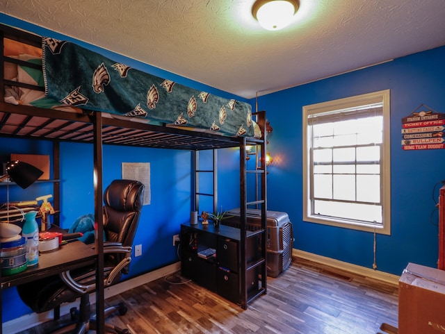 1047 Fort Hl, Portland, TN 37148 - bedroom featuring baseboards, a textured ceiling, and wood finished floors