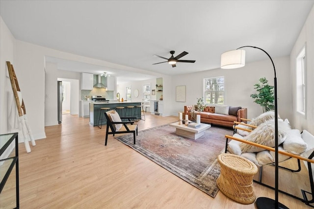 living room featuring light wood-style floors and ceiling fan