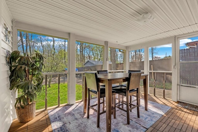 sunroom / solarium featuring outdoor dining area