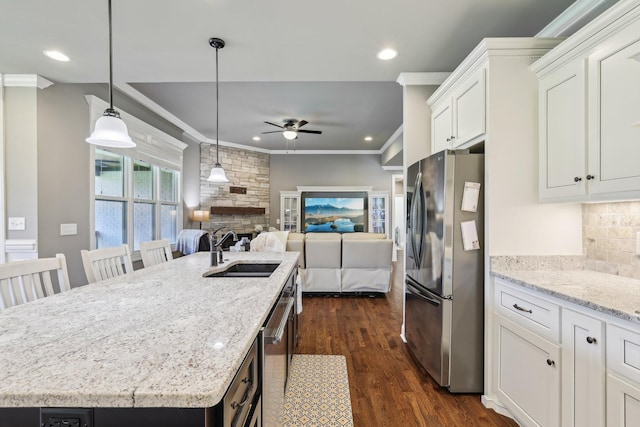 2042 Imagine Cir, Spring Hill, TN 37174 - kitchen with appliances with stainless steel finishes, a sink, ceiling fan, a fireplace, and open floor plan