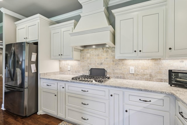 2042 Imagine Cir, Spring Hill, TN 37174 - kitchen featuring appliances with stainless steel finishes, custom exhaust hood, crown molding, dark wood-type flooring, and backsplash