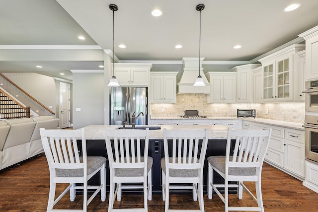 2042 Imagine Cir, Spring Hill, TN 37174 - kitchen with stainless steel appliances, custom range hood, a sink, crown molding, and a kitchen island with sink