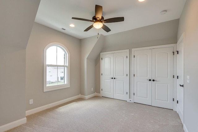 2042 Imagine Cir, Spring Hill, TN 37174 - unfurnished bedroom featuring multiple closets, light colored carpet, baseboards, vaulted ceiling, and recessed lighting