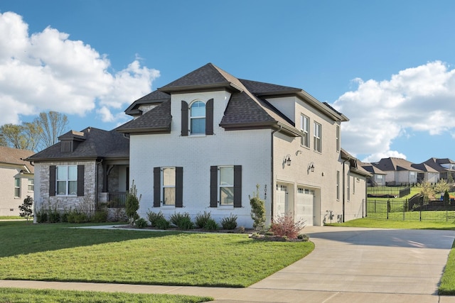 2042 Imagine Cir, Spring Hill, TN 37174 - french provincial home featuring an attached garage, concrete driveway, a shingled roof, brick siding, and a residential view