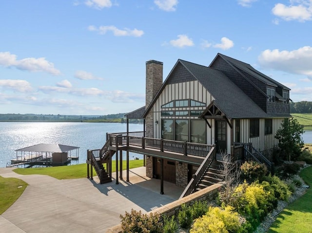 exterior space featuring a water view, stairway, board and batten siding, and a dock
