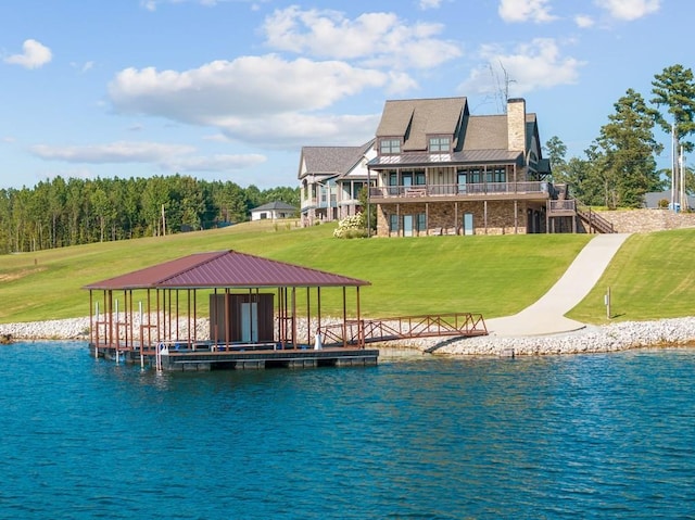 back of property with a yard, stairway, a water view, and a chimney