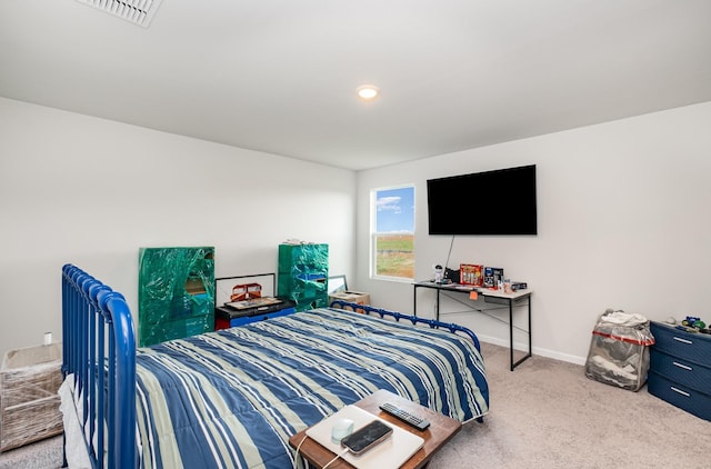 carpeted bedroom with baseboards and visible vents