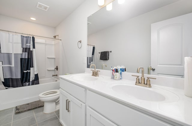bathroom with double vanity, a sink, tile patterned flooring, and visible vents