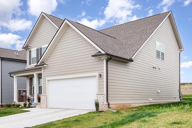 view of side of home featuring a shingled roof, driveway, and brick siding