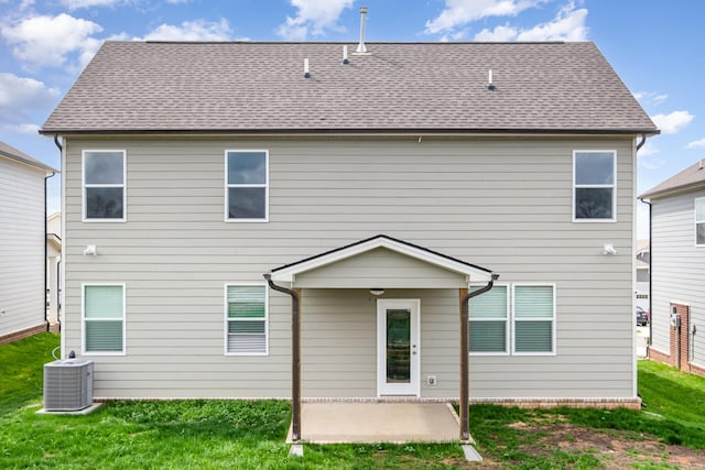 rear view of house featuring central AC, a patio, and a yard