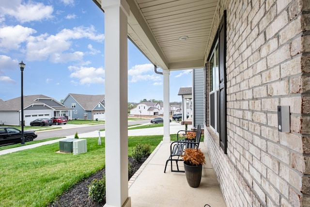 view of patio / terrace with a residential view and covered porch