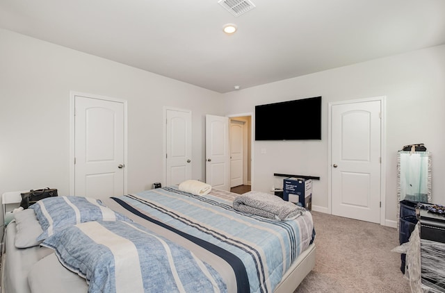 bedroom featuring visible vents, baseboards, and light colored carpet