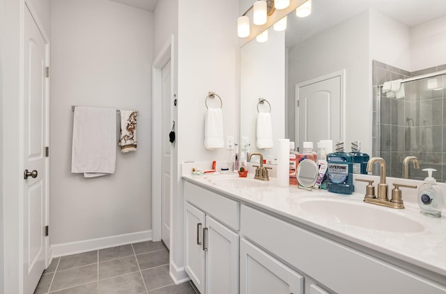 bathroom featuring a sink, double vanity, tile patterned flooring, and a stall shower
