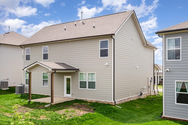 back of property featuring central air condition unit, a patio, and a yard