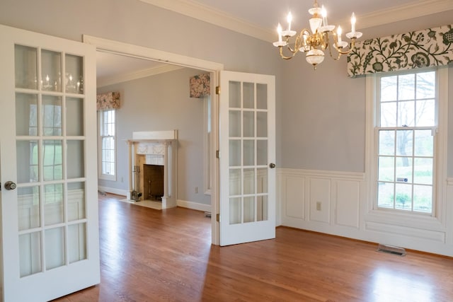 1601 Harvie Mills Rd W, Cookeville, TN 38501 - unfurnished dining area with crown molding, wood finished floors, an inviting chandelier, and visible vents