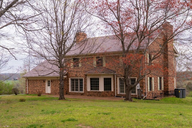 1601 Harvie Mills Rd W, Cookeville, TN 38501 - back of house featuring a yard, brick siding, and a chimney
