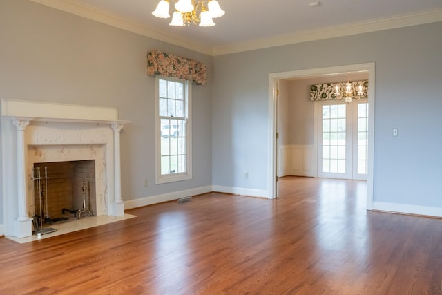 1601 Harvie Mills Rd W, Cookeville, TN 38501 - unfurnished living room featuring crown molding, wood finished floors, and a notable chandelier