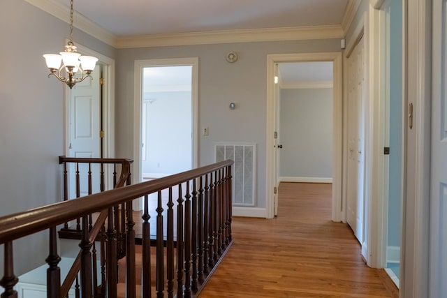 1601 Harvie Mills Rd W, Cookeville, TN 38501 - corridor with visible vents, a notable chandelier, ornamental molding, an upstairs landing, and light wood finished floors